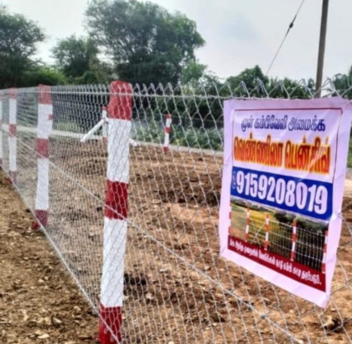 Chain-link fence stretching across open farmland